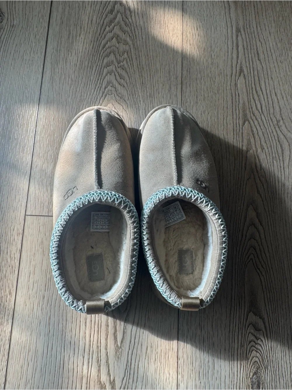 UGG women’s Slip-On Suede Slippers in Light Brown with Blue Trim